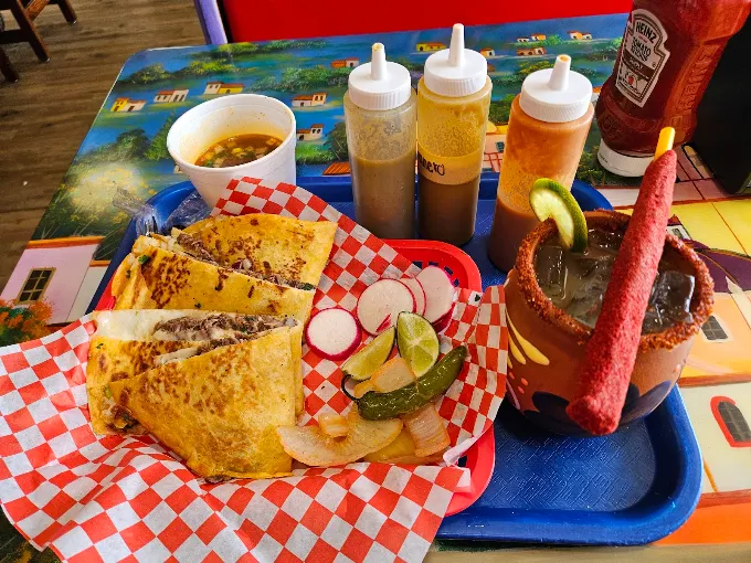 Quesabirria tacos, consomé and a michelada