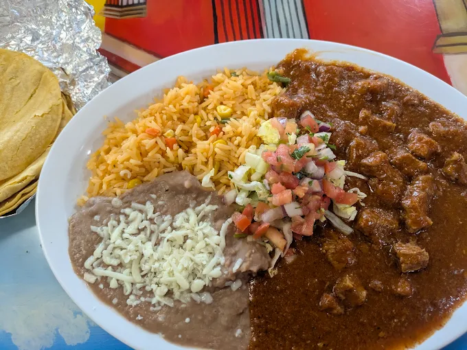 Chile Colorado with rice, beans and tortillas
